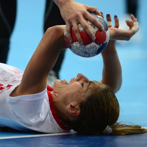 Croatia's right back Andrea Penezic reacts after a fall during the women's quarterfinal handball match against Spain.