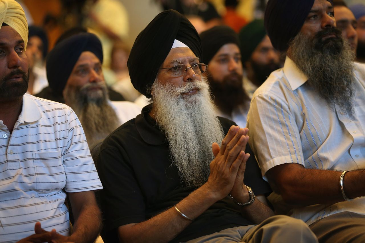 Members of the Miwaukee-area Sikh community gather to learn information about the shooting spree of Wade Michael Page, 40, on Monday, August 6 in Oak Creek, Wisconsin.