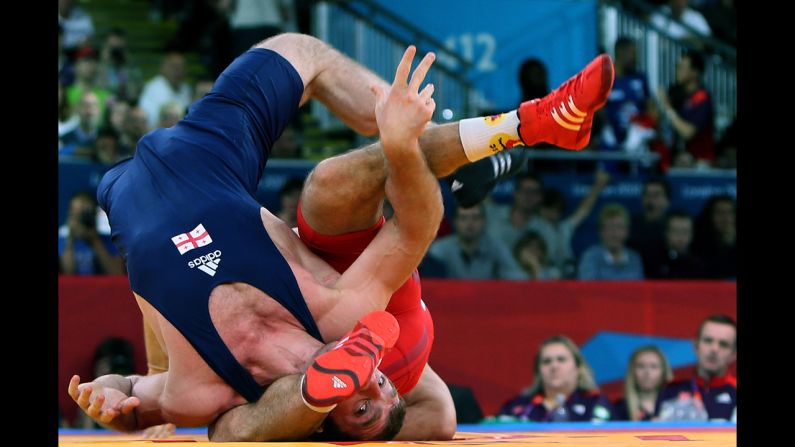 Georgia's Manucher Tskhadaia, left, wrestles Hungary's Tamas Lorincz during the 96-kilogram Greco-Roman semifinal on Tuesday.