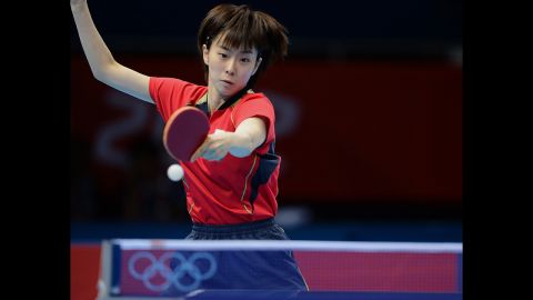 Japan's Kasumi Ishikawa returns the ball to China's Ding Ning during the women's team table tennis gold medal match.