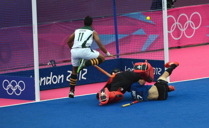 Facundo Callioni of Argentina, right, scores a goal against South Africa during the field hockey preliminary round match.