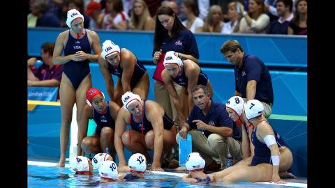 United States water polo coach Adam Krikorian talks with his players during the women's semifinal match against Australia.