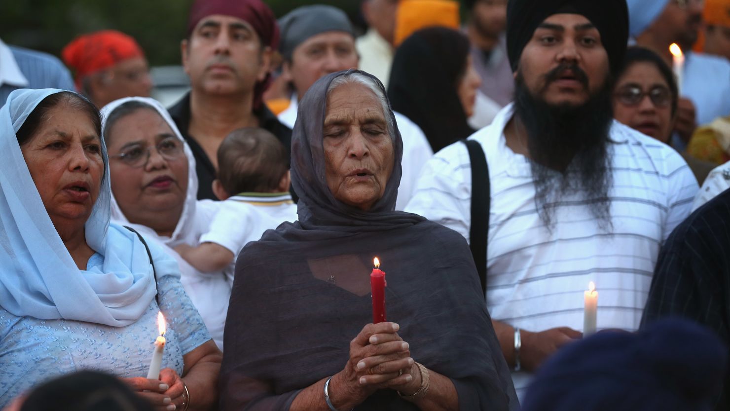 Guests attend a vigil at the Illinois Sikh Community Center on August 6 to honor the victims of the Wisconsin temple massacre