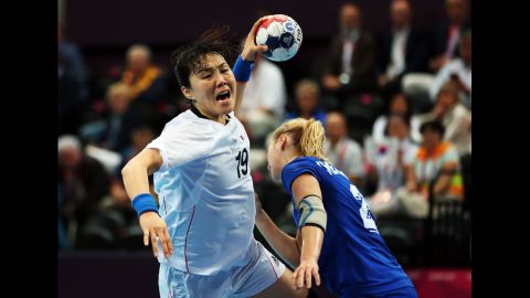 Im Jeong Choi, No. 19 of Korea, shoots over Olga Chernoivanenko, No. 29 of Russia, during the women's quarterfinal match between Russia and Korea on Tuesday.