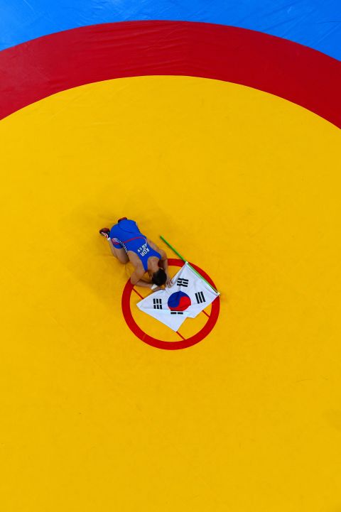South Korea's Kim Hyeon-woo bows to the mat after winning the men's 66 kilogram Greco-Roman gold medal fight against Hungary's Tamas Lorincz.