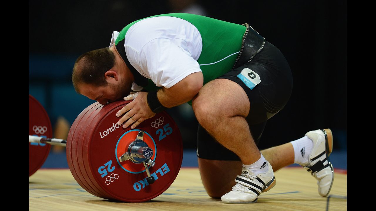 Peter Nagy of Hungary misunderstands sport, attempts to roll barbell.