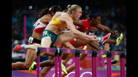 Sally Pearson of Australia leads Nevin Yanit of Turkey and Kellie Wells of the United States during the women's 100-meter hurdles final.