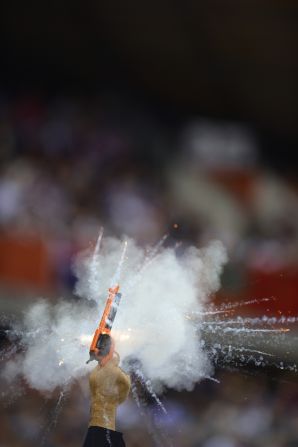 A referee fires the gun to start a race of the the London 2012 Olympic Games cycling event at the velodrome in the Olympic Park.