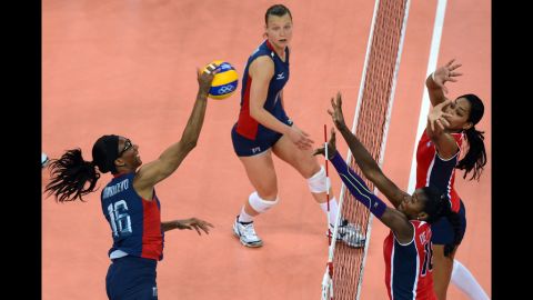 Foluke Akinradewo, left, of the United States spikes during the women's quarterfinal volleyball match between the USA and the Dominican Republic.