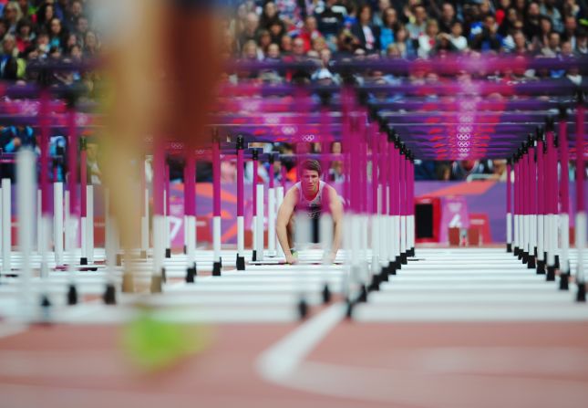Andrew Pozzi of Great Britain watches after pulling out of the men's 110-meter hurdles round 1 heats.