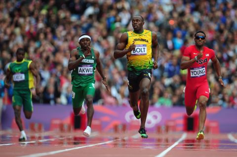 Usain Bolt of Jamaica leads Noah Akwu of Nigeria and Isiah Young of the United States in the men's 200-meter round qualifier on day 11 of the London 2012 Olympics at Olympic Stadium on Tuesday, August 7.