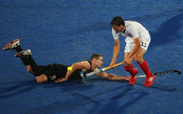 Tobias Hauke of Germany and Phillip Burrows of New Zealand challenge for the ball during the men's hockey match between Germany and New Zealand.