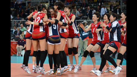 South Korea's players celebrate their victory in the women's quarterfinal volleyball match between Italy and South Korea.