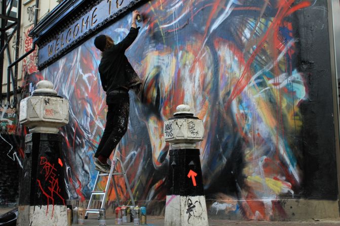 The area around Shoreditch and Brick Lane has become popular with street artists from around the world.  Here is David Walker putting up a piece just off Brick Lane.