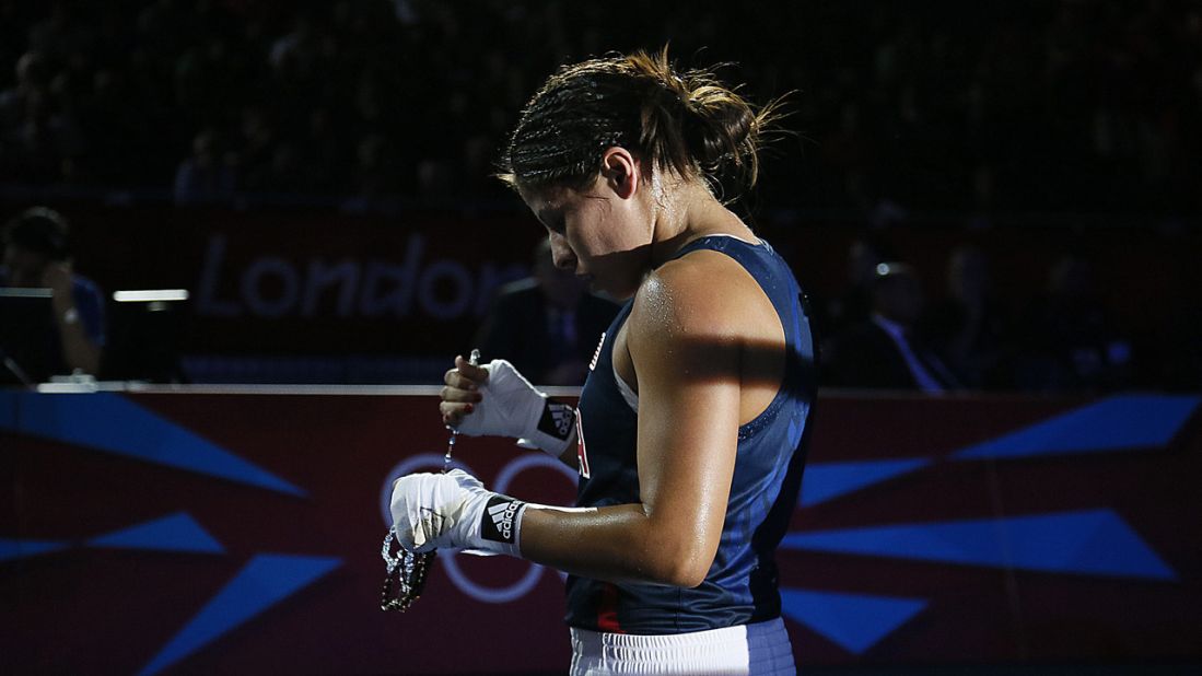 Marlen Esparza of the United States leaves the ring following her loss to Cancan Ren of China in the women's flyweight boxing semifinals.