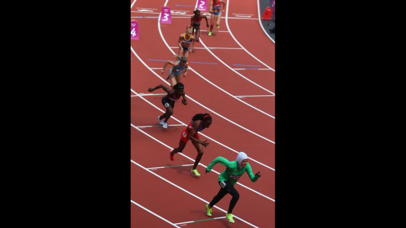 Saudi Arabia's Sarah Attar, right, competes in round one of the women's 800-meter heats.