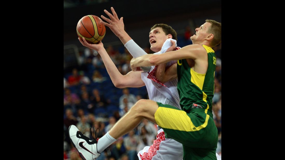 Russian center Timofey Mozgov, left, is challenged by Lithuanian guard Renaldas Seibutis during the men's quarterfinal basketball match.