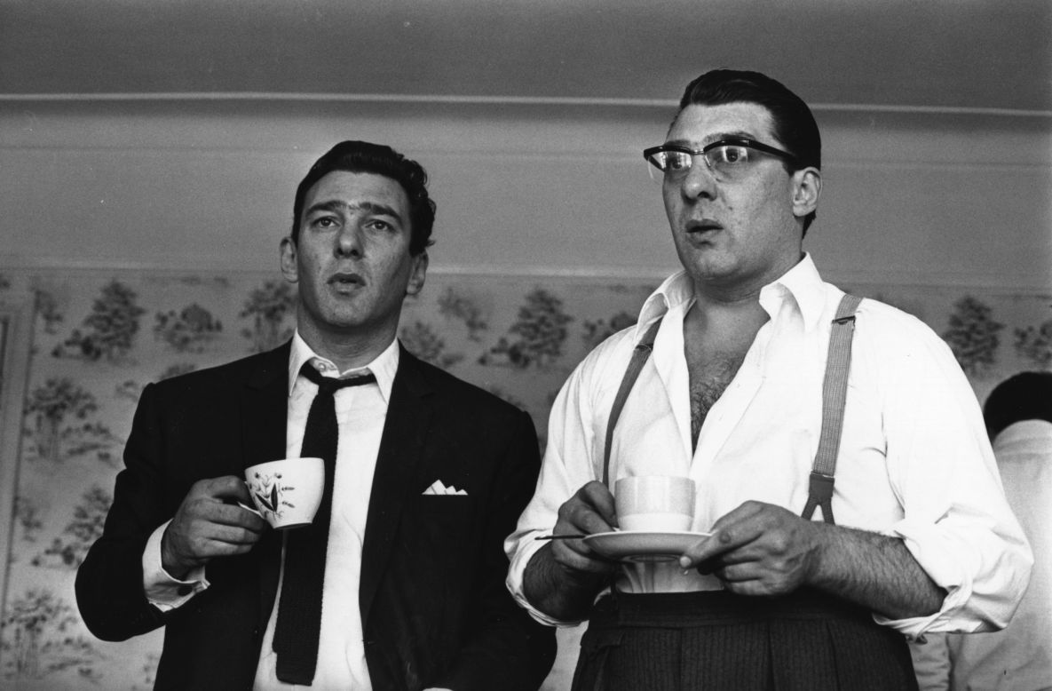 The <a href="http://www.met.police.uk/history/krays.htm" target="_blank" target="_blank">Kray twins</a>, Ronnie (left) and Reggie, enjoy a cup of tea in 1966 after they had been questioned by police about the murder of George Cornell. The pair ran several protection rackets across East London during the 1950s and 1960s, mixing violence with appearances alongside celebrities at nightspots. East London's most notorious criminals of the 20th-century were eventually jailed in 1968 for murder (Getty Images).