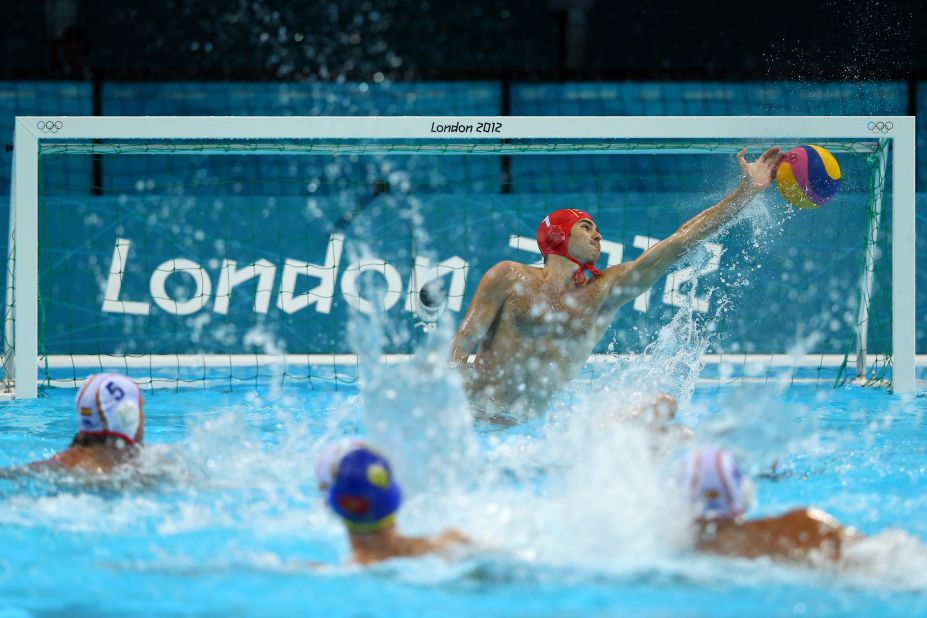 Spain's Blai Mallarach Guell, center, makes a save in the men's water polo quarterfinal match against Montenegro.