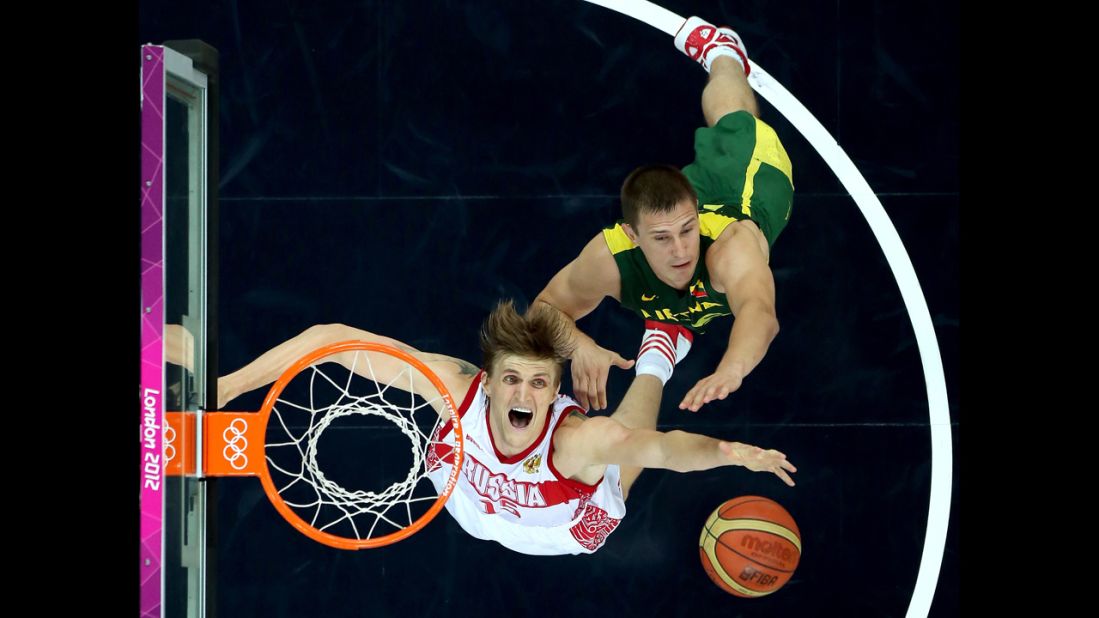 Russia's Andrei Kirilenko, left, and Paulius Jankunas of Lithuania go up for a rebound during the men's basketball quarterfinal game.