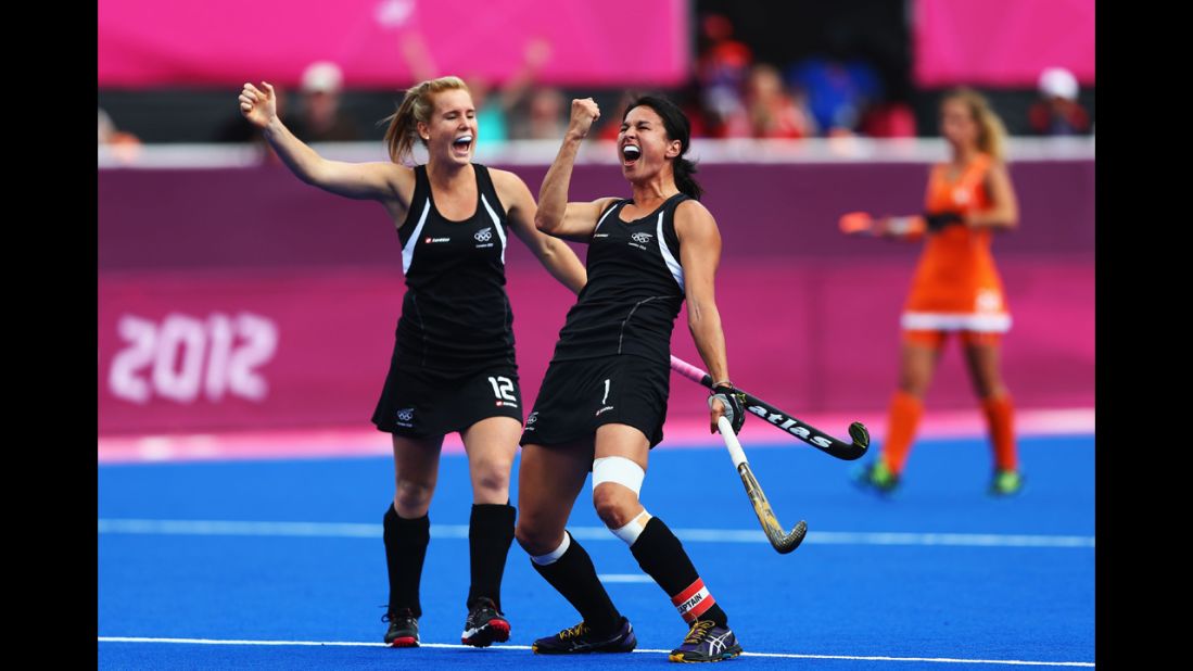 New Zealand's Ella Gunson, left, and Kayla Sharland celebrate after Sharland scores their team's first goal during the women's field hockey semifinal match against the Netherlands.