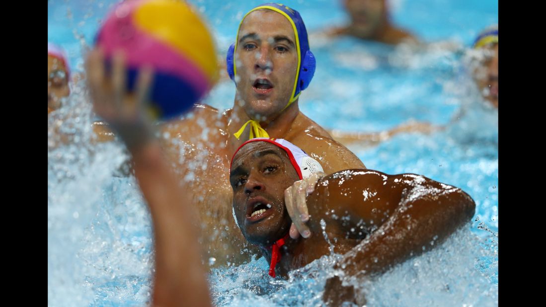 Nikola Janovic, top, of Montenegro and Ivan Perez Vargas of Spain compete in the men's water polo quarterfinal match.