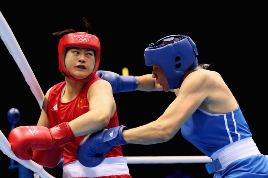 Jinzi Li, left, of China battles Nadezda Torlopova of Russia during the women's middle 75-kilogram boxing semifinals.