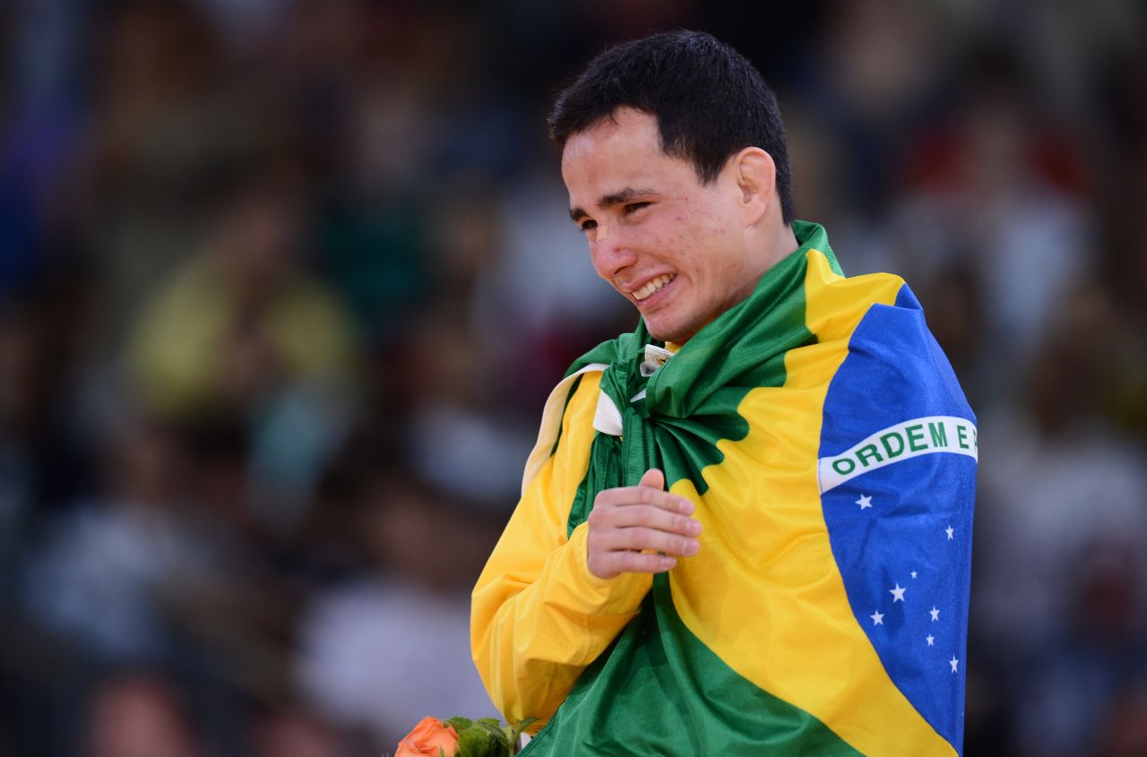 Brazil's bronze medalist Felipe Kitadai cries on the podium after the men's lightweight judo match.