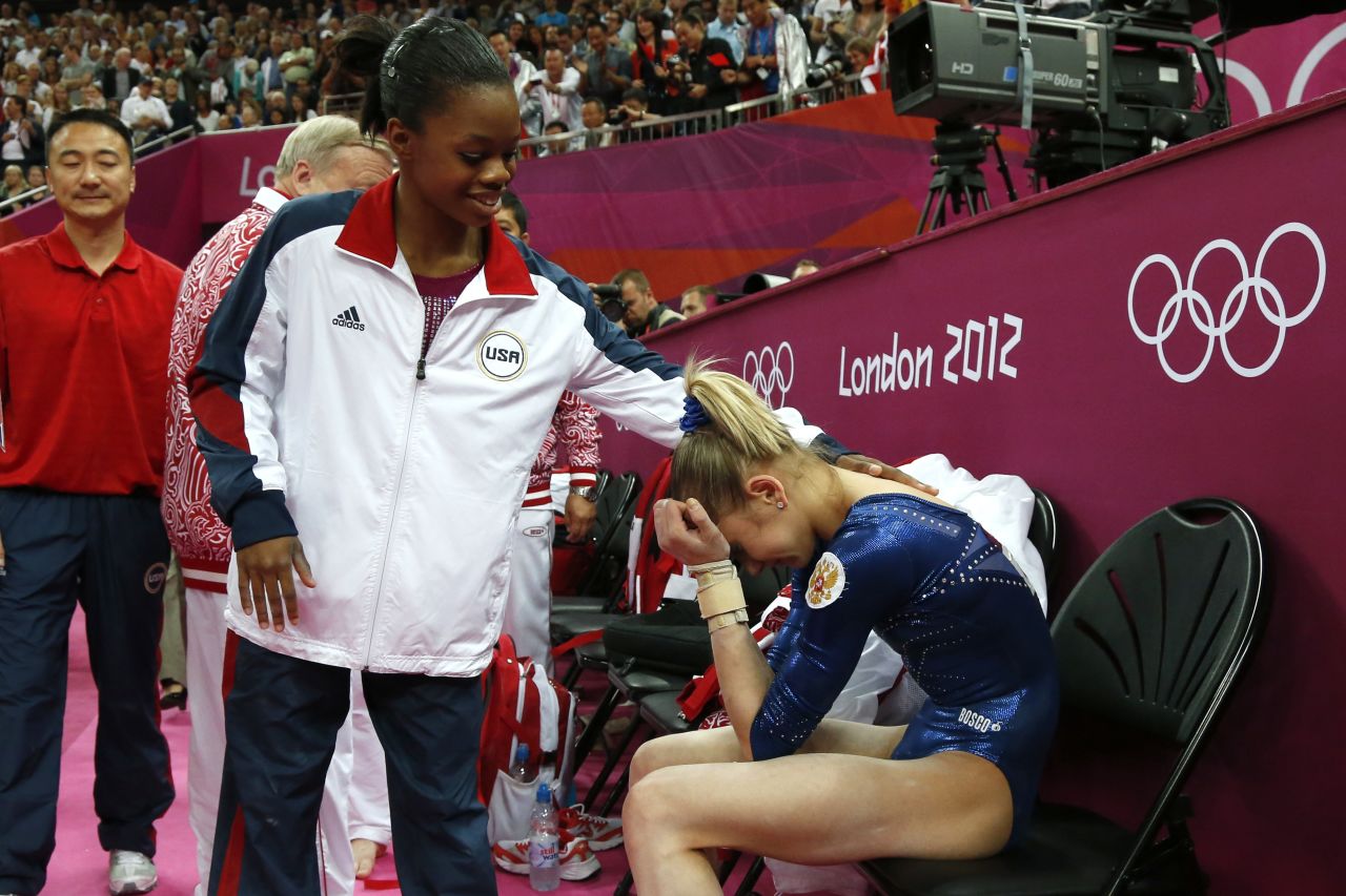 American gymnast Gabby Douglas, left, comforts Russia's Victoria Komova during the women's individual all-around competition. Douglas won the gold while Komova took silver.
