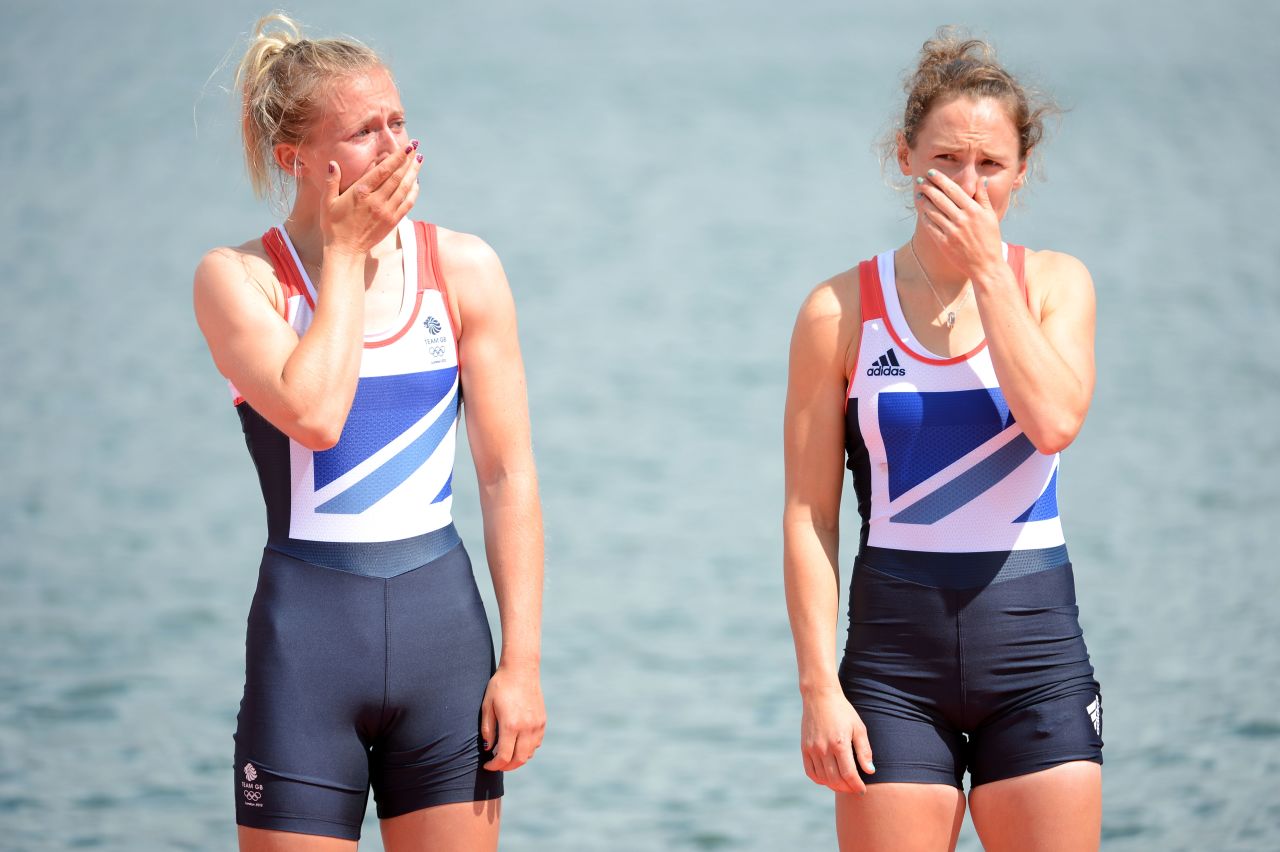 Katherine Copeland and Sophie Hosking of Great Britain cry before receiving their gold medals for the lightweight women's double sculls.