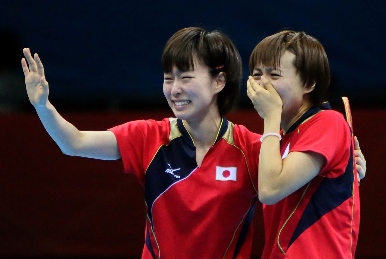 Japanese table tennis players Kasumi Ishikawa, left, and Sayaka Hirano weep after beating Singapore in the women's team semifinal match.