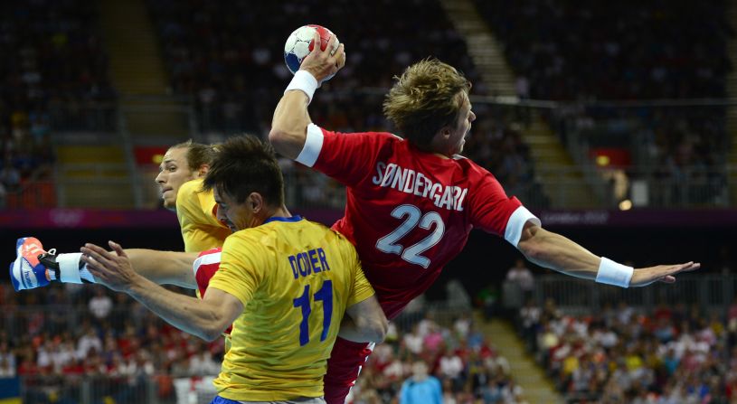 Denmark right back Kasper Sondergaard Sarup, center, shoots during the men's quarterfinal handball match against Sweden at the London Olympics on Wednesday, August 8. 
