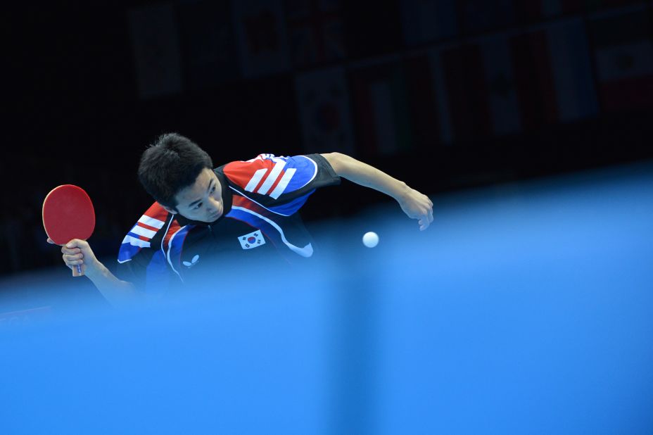 South Korea's Joo Se-Hyuk returns a ball to China's Zhang Jike during the table tennis men's team final.
