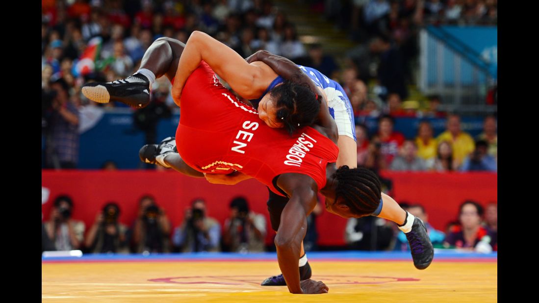 Senegal's Isabelle Sambou, in red, and Canadian Carol Huynh compete in women's freestyle 48-kilogram wrestling on Day 12 of the London 2012 Olympic Games.