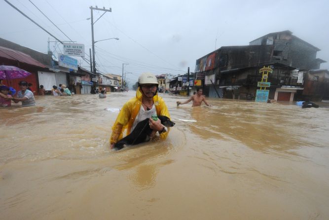 Residents are evacuated from their flooded homes in the village of Tumana, Marikina town, in suburban Manila.