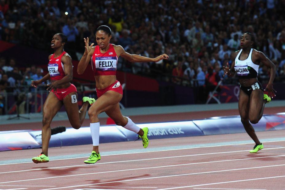 Allyson Felix of the United States crosses the finish line ahead of Murielle Ahoure of Cote d'Ivoire and Carmelita Jeter of the United States to win the women's 200-meter final.