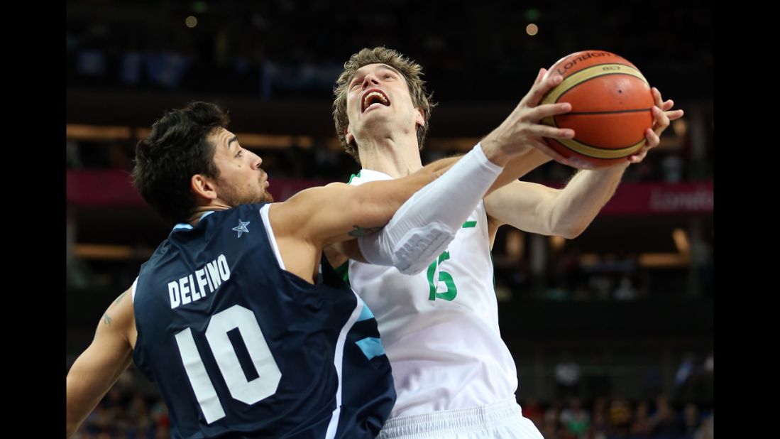 Tiago Splitter of Brazil goes up for a shot against Carlos Delfino of Argentina in the first half of the men's basketball quaterfinal game.
