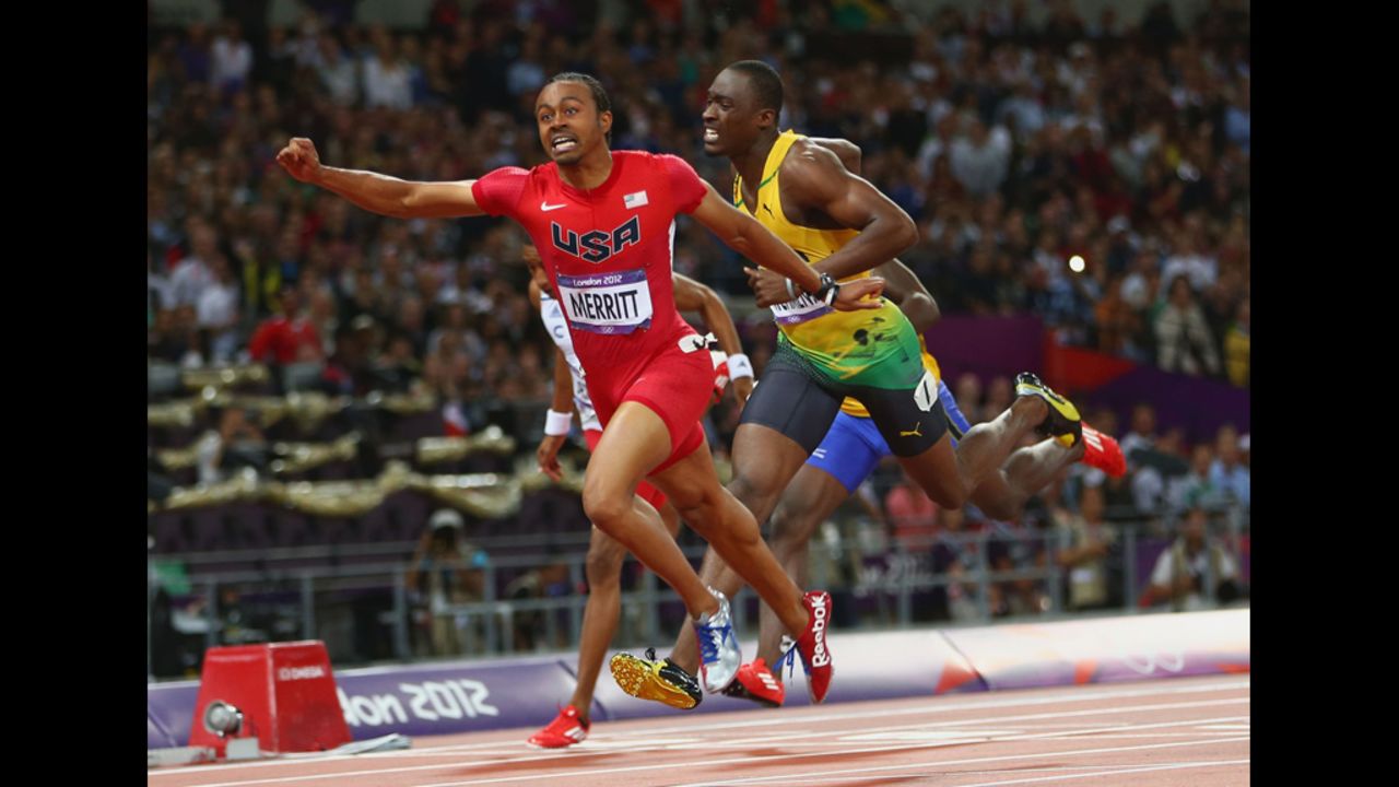 Aries Merritt of the United States crosses the finish line ahead of Hansle Parchment of Jamaica to win gold in the men's 110-meter hurdles final.