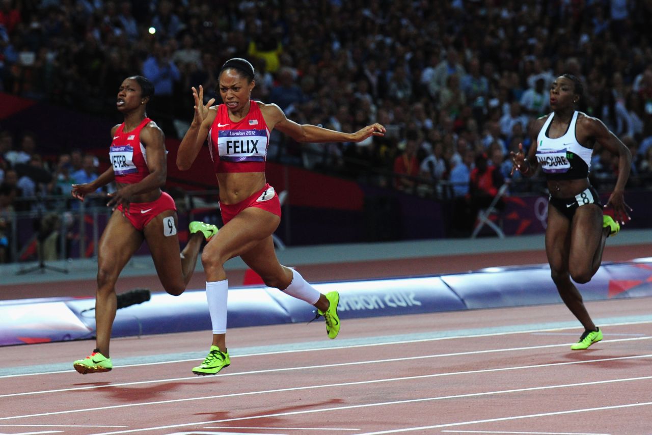 Allyson Felix of the United States crosses the finish line ahead of Murielle Ahoure of Cote d'Ivoire and Carmelita Jeter of the United States to win the women's 200-meter final on Wednesday.