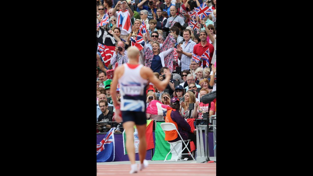 Spectators cheer Daniel Awde of Great Britain after the men's decathlon 100-meter heats.