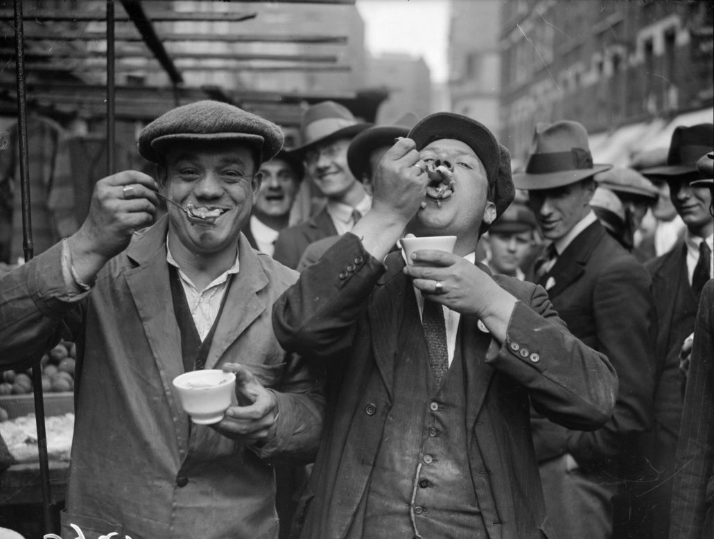 Two men enjoy jellied eels, an East End delicacy, in Whitechapel on a Sunday morning in September 1927. Eels became a staple dish of East London over the centuries due to their prevalence in the River Thames. They are much less popular now but can still be found in <a href="http://www.timeout.com/london/restaurants/features/7721/London-s_best_pie_and_mash.html" target="_blank" target="_blank">certain eatries</a>, where they are served with pie -- which usually contains beef -- and mash (Getty Images).