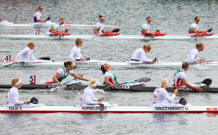 In Boat 5, from left, Hungary's Krisztina Fazekas, Katalin Kovacs and Danuta Kozak celebrate winning the gold medal in the women's kayak four 500-meter sprint final in Windsor.