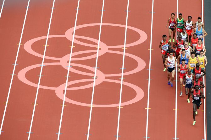 Athletes compete in round one of the men's 5,000-meter heats at Olympic Stadium. Check out <a href="index.php?page=&url=http%3A%2F%2Fwww.cnn.com%2F2012%2F08%2F09%2Fworldsport%2Fgallery%2Folympics-day-thirteen%2Findex.html" target="_blank">Day 13 of the competition</a> from Thursday, August 9.