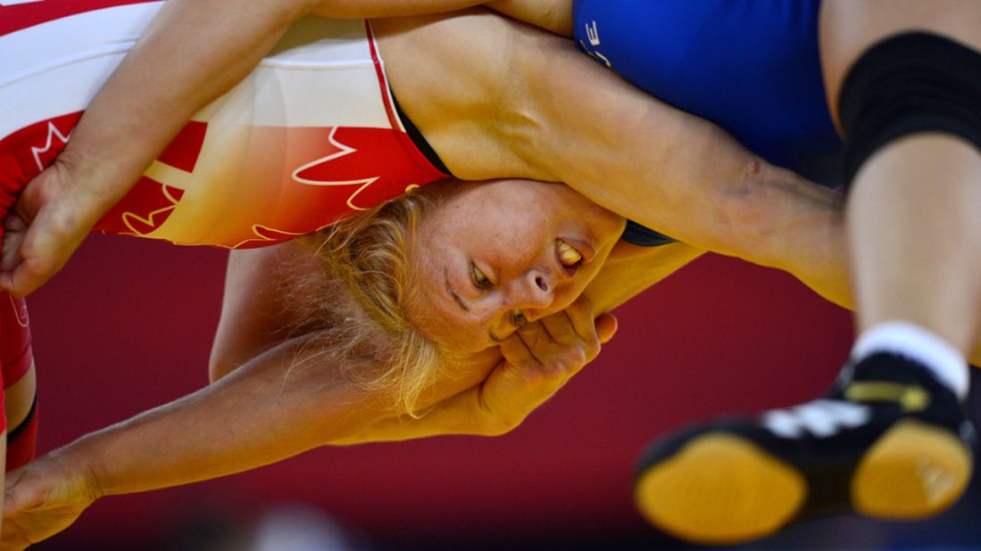 Canada's Martine Dugrenier, right, wrestles Sweden's Henna Johansson in their women's 63 kilogram freestyle repechage round 2 match.