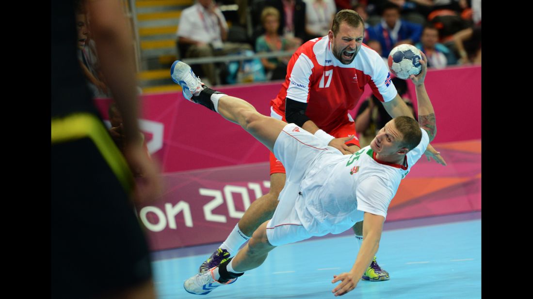 Iceland's Sverre Jakobsson, top, vies with Hungary's Szabolcs Zubai during the men's quarterfinal handball match.