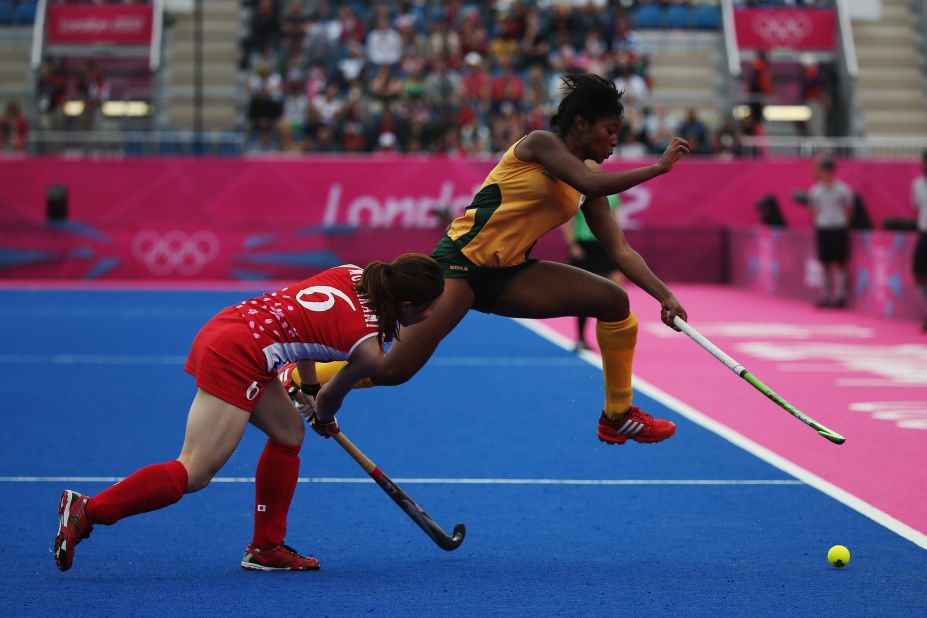 Japan's Murakami Ai, left, and Sulette Damons of South Africa vie for the ball during the women's field hockey classification match.