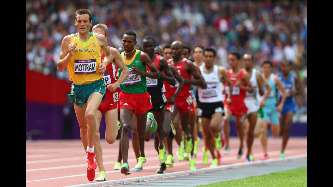 Australia's Craig Mottram leads in round one of the men's 5,000-meter heats at Olympic Stadium.