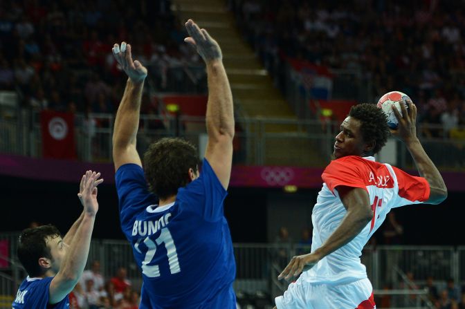 Tunisia's left back Wael Jallouz, right, prepares to shoot during the men's quarterfinal handball match between Croatia and Tunisia.