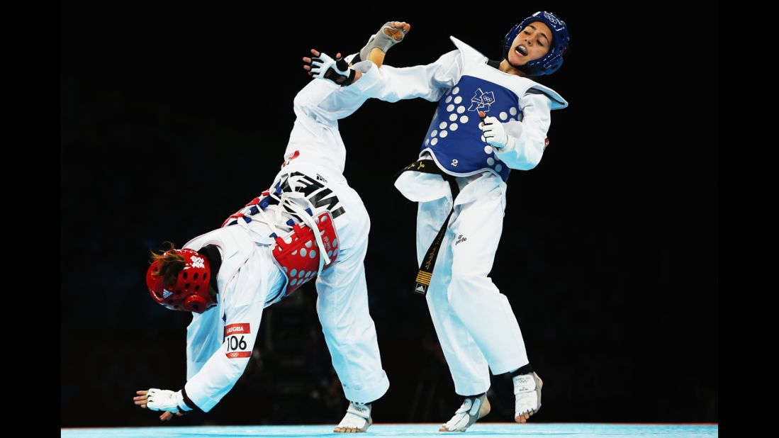 Mexico's Jannet Alegria Pena, left, competes against Raya Hatahet of Jordan during the women's taekwondo under 49-kilogram preliminary round.