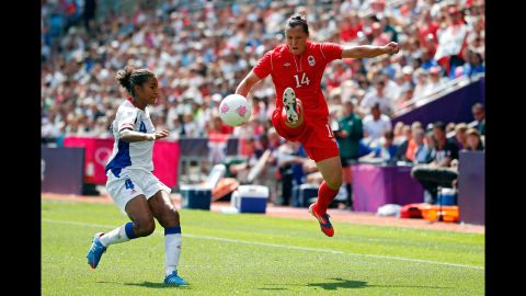 Canada's Melissa Tancredi, right, handles the ball against France's Laura Georges during the women's football bronze medal match.